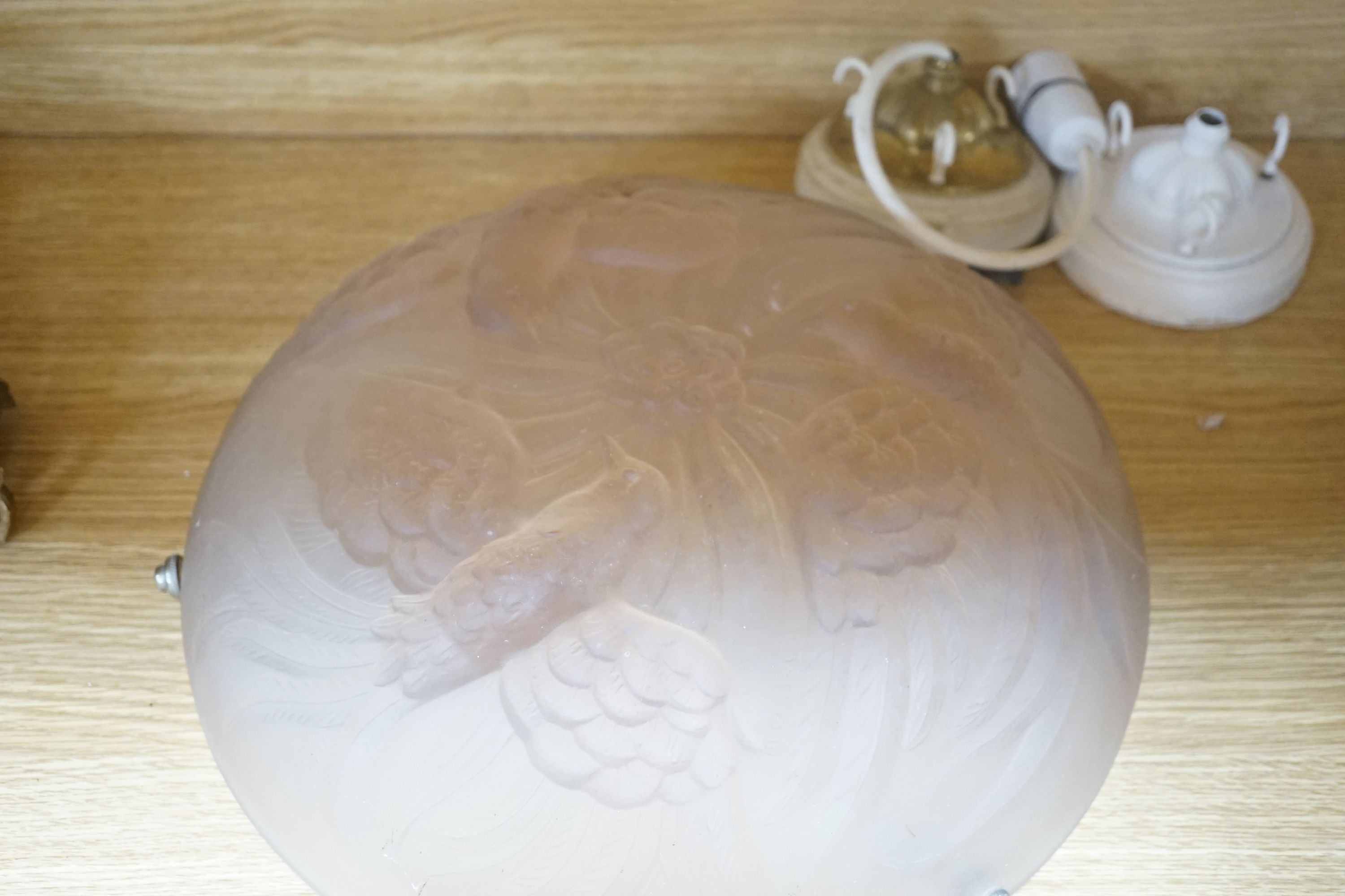 Two 1930s pink frosted glass plafonnier lights, one decorated with birds the other flowers, 36 cms diameter.